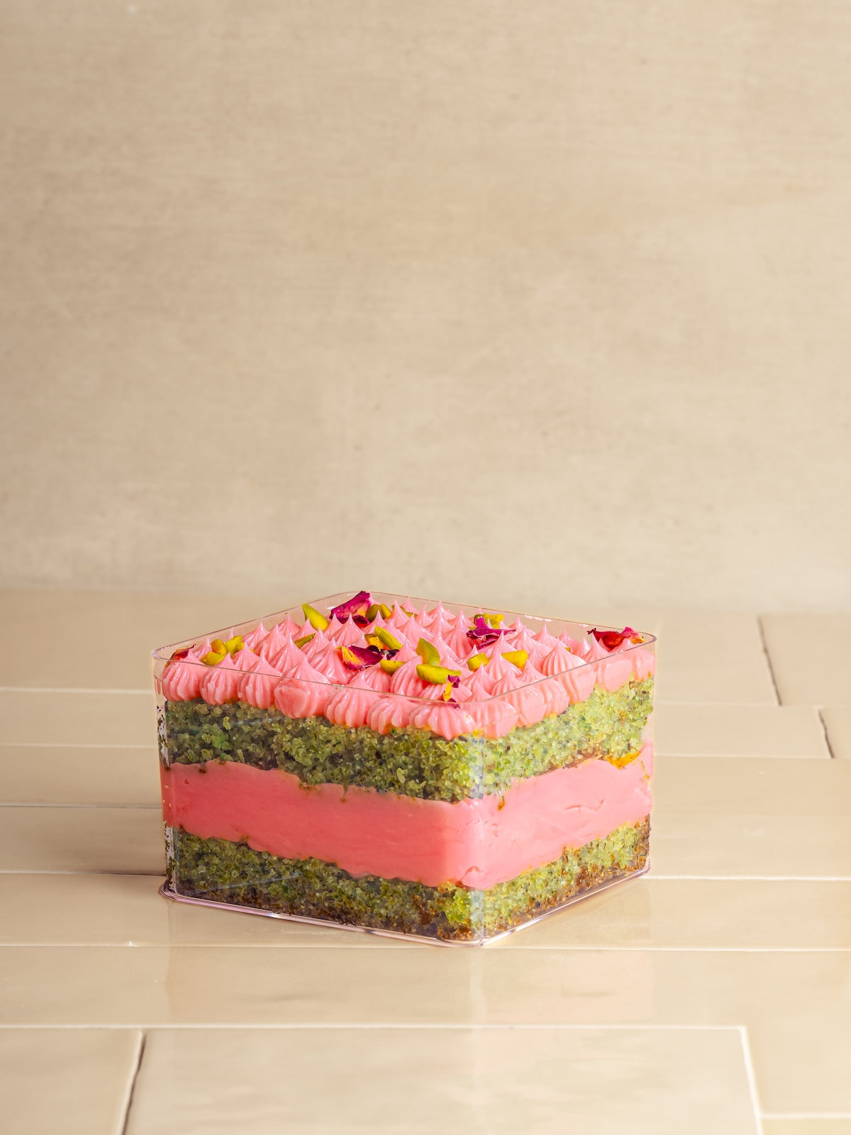 Pistachio cake with pistachio praline & feulittine frosted with rose buttercream