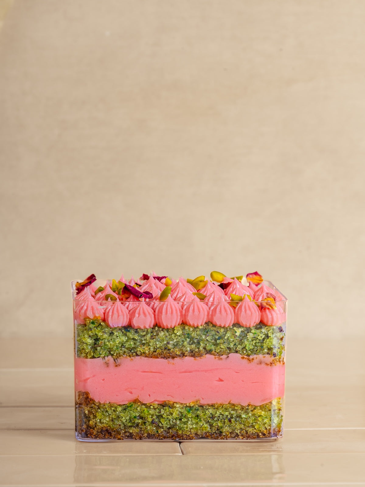Pistachio cake with pistachio praline & feulittine frosted with rose buttercream