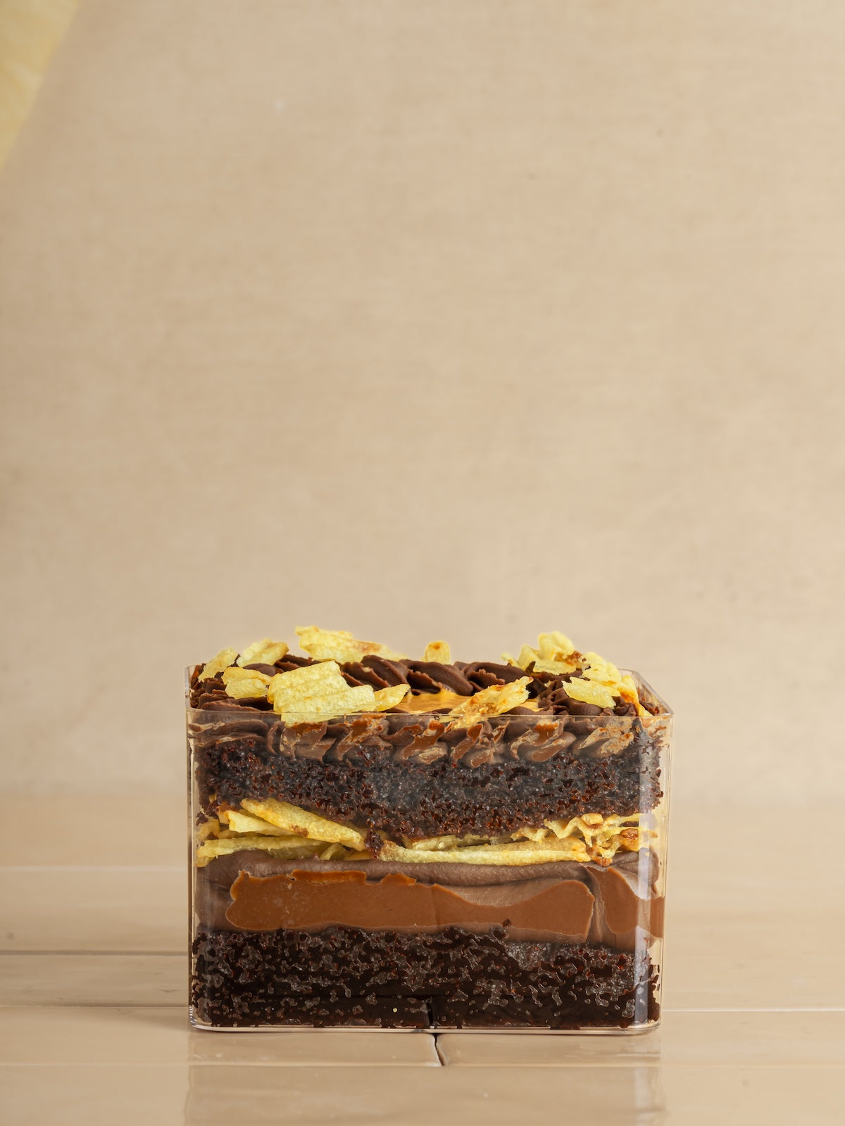 Chocolate cake with whipped caramel, caramelized potato chips & fudge frosting