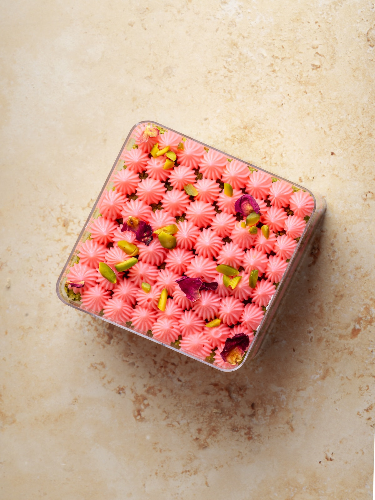 Pistachio cake with pistachio praline & feulittine frosted with rose buttercream
