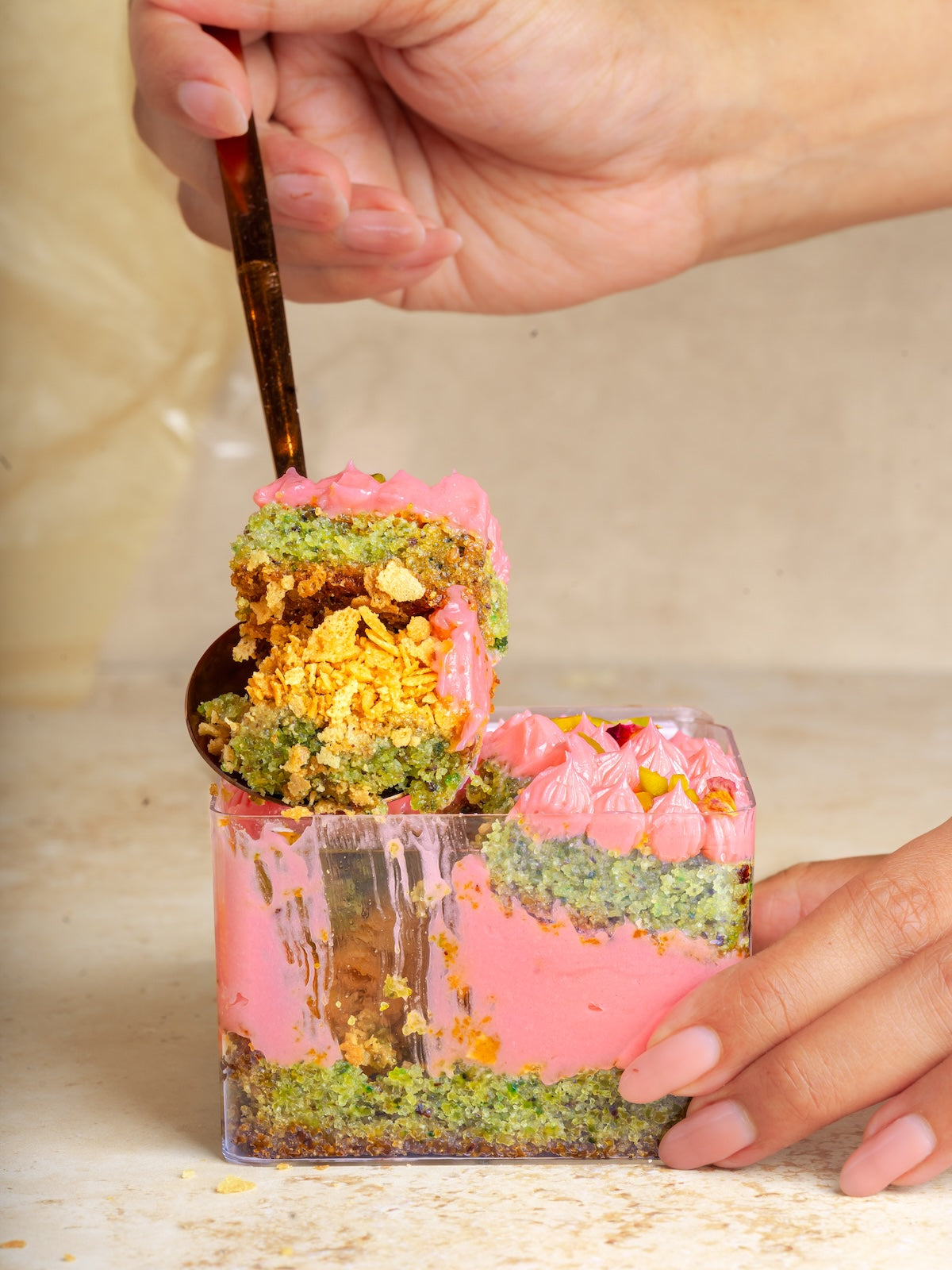 Pistachio cake with pistachio praline & feulittine frosted with rose buttercream